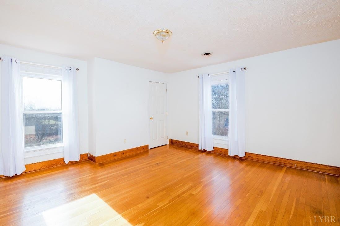 3655 Lowry Road Goode, VA 24556 - Photo 24 of 46 a view of empty room with wooden floor and fan