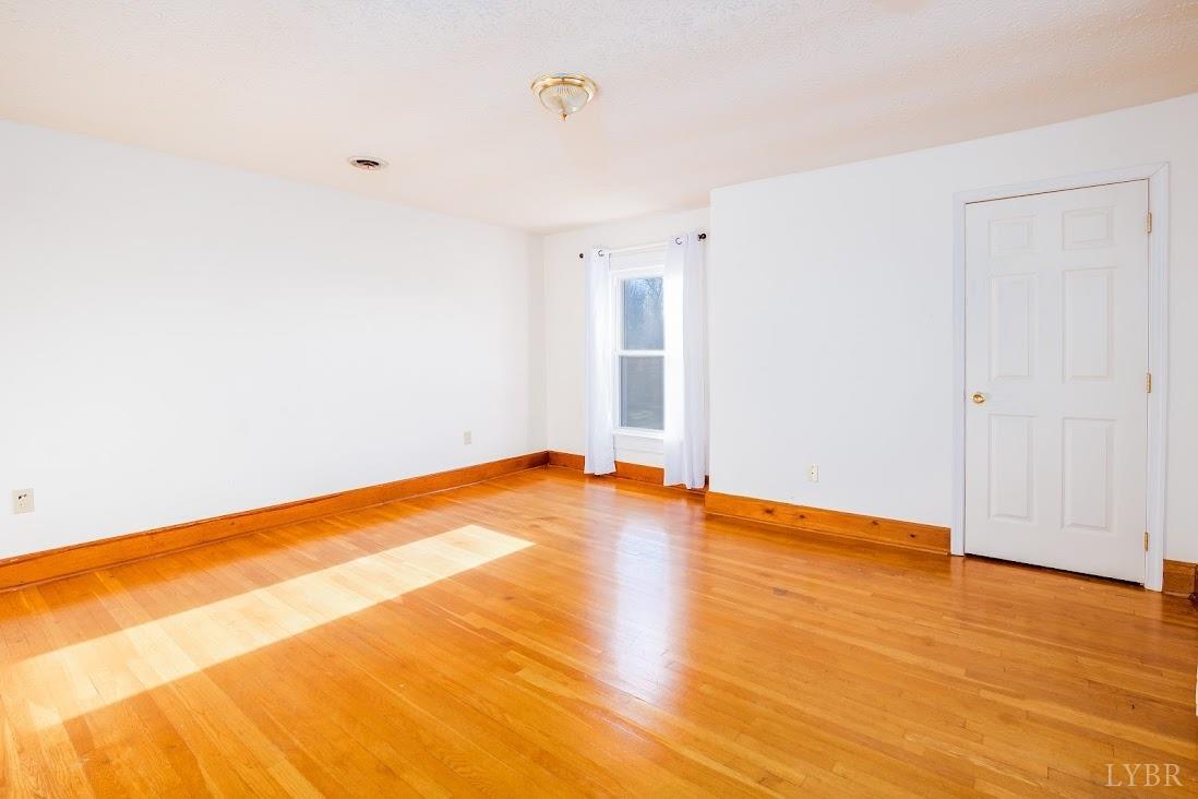 3655 Lowry Road Goode, VA 24556 - Photo 25 of 46 a view of empty room with wooden floor