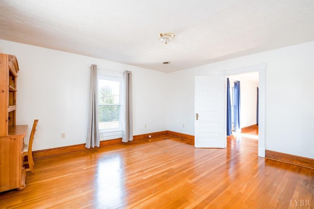 3655 Lowry Road Goode, VA 24556 - Photo 28 of 46 a view of empty room with wooden floor and fan