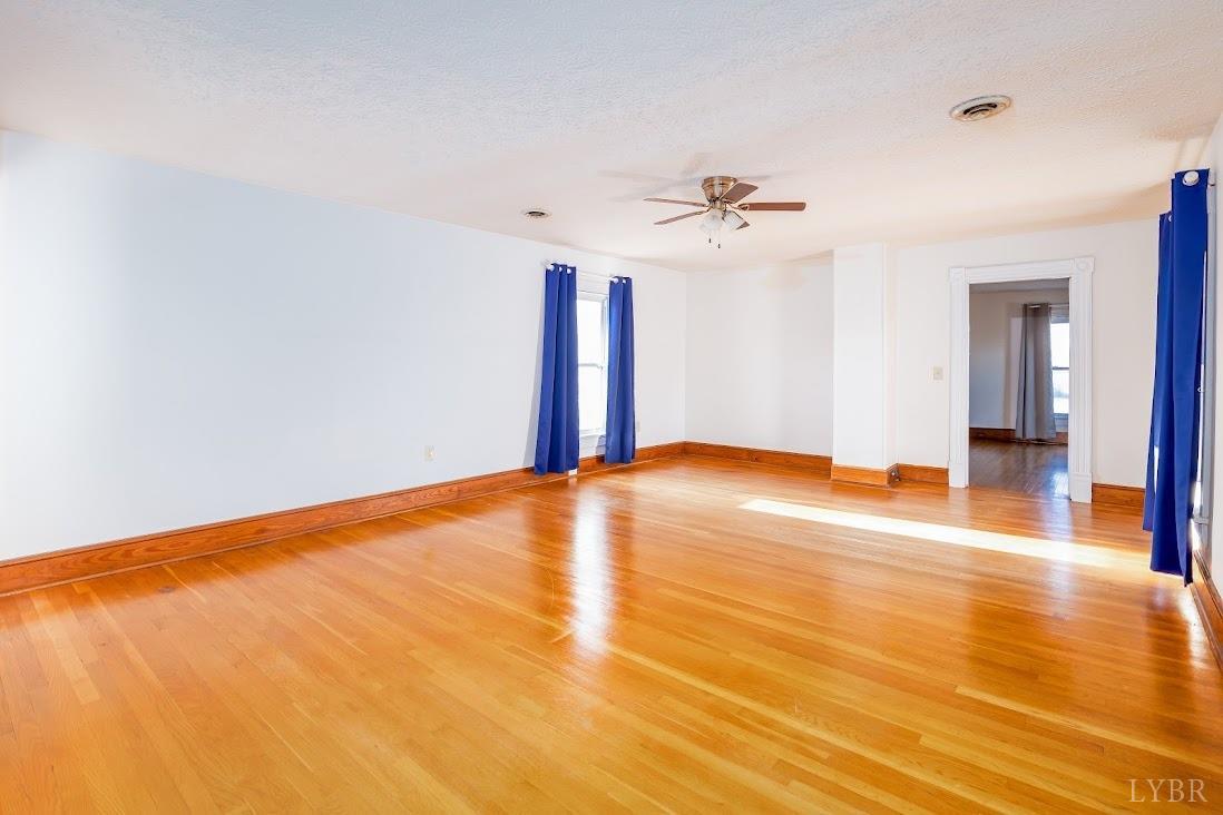 3655 Lowry Road Goode, VA 24556 - Photo 32 of 46 a view of a room with wooden floor and ceiling fan
