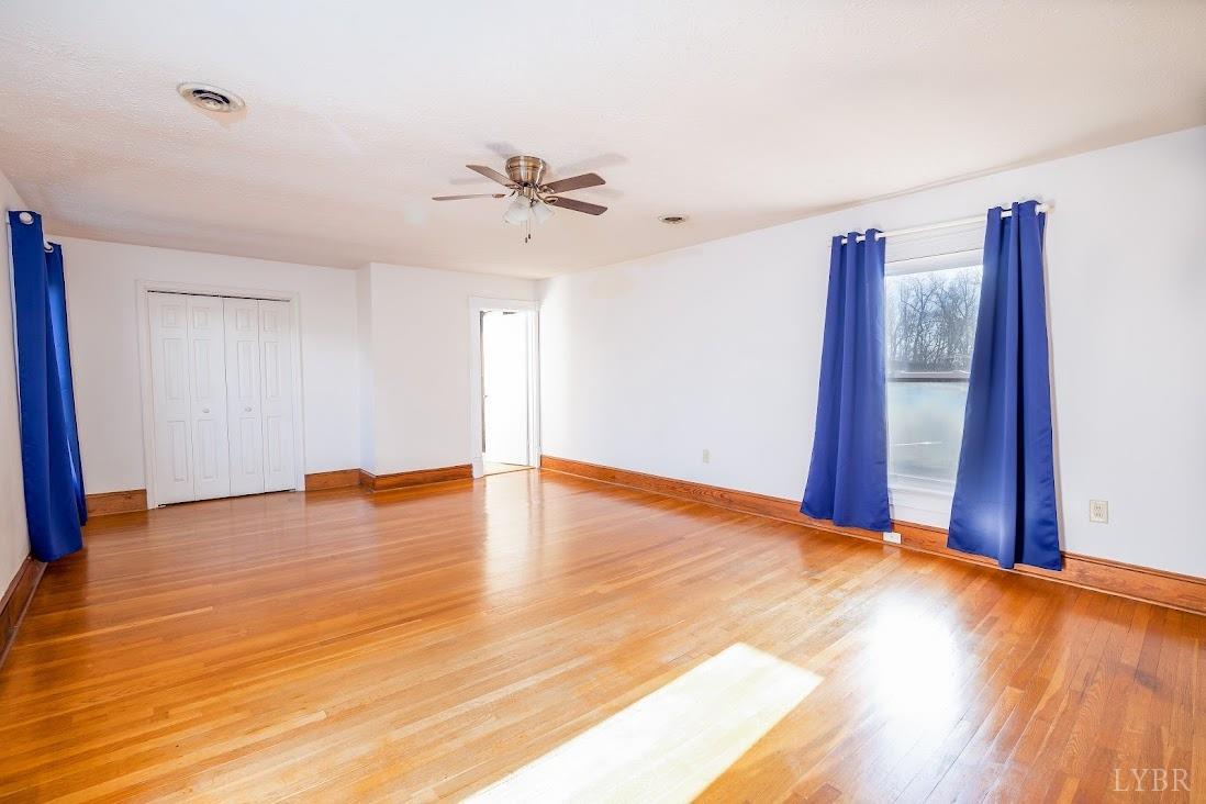 3655 Lowry Road Goode, VA 24556 - Photo 33 of 46 a view of an empty room with window and wooden floor