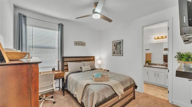 a bedroom with a bed and a desk