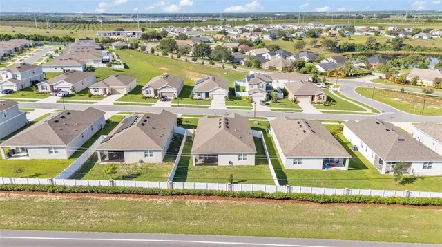 an aerial view of residential houses with outdoor space
