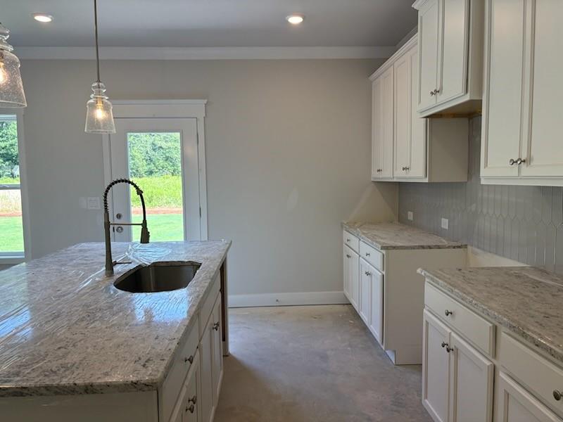6 Commons Way Cartersville, GA 30120 - Photo 4 of 37 a kitchen with granite countertop a sink a counter and a stove