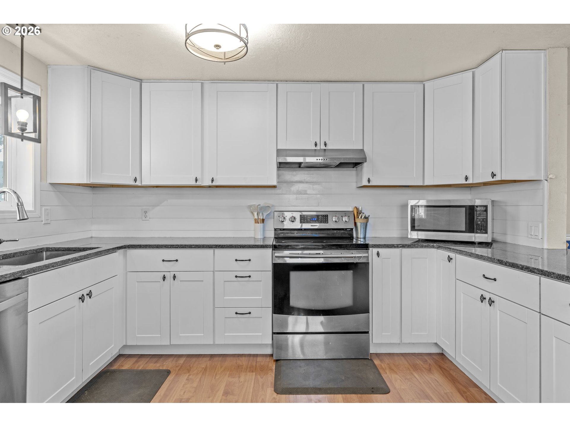 402 Clover Street Aumsville, OR 97325 - Photo 11 of 26 a kitchen with stainless steel appliances granite countertop a stove a sink and a microwave