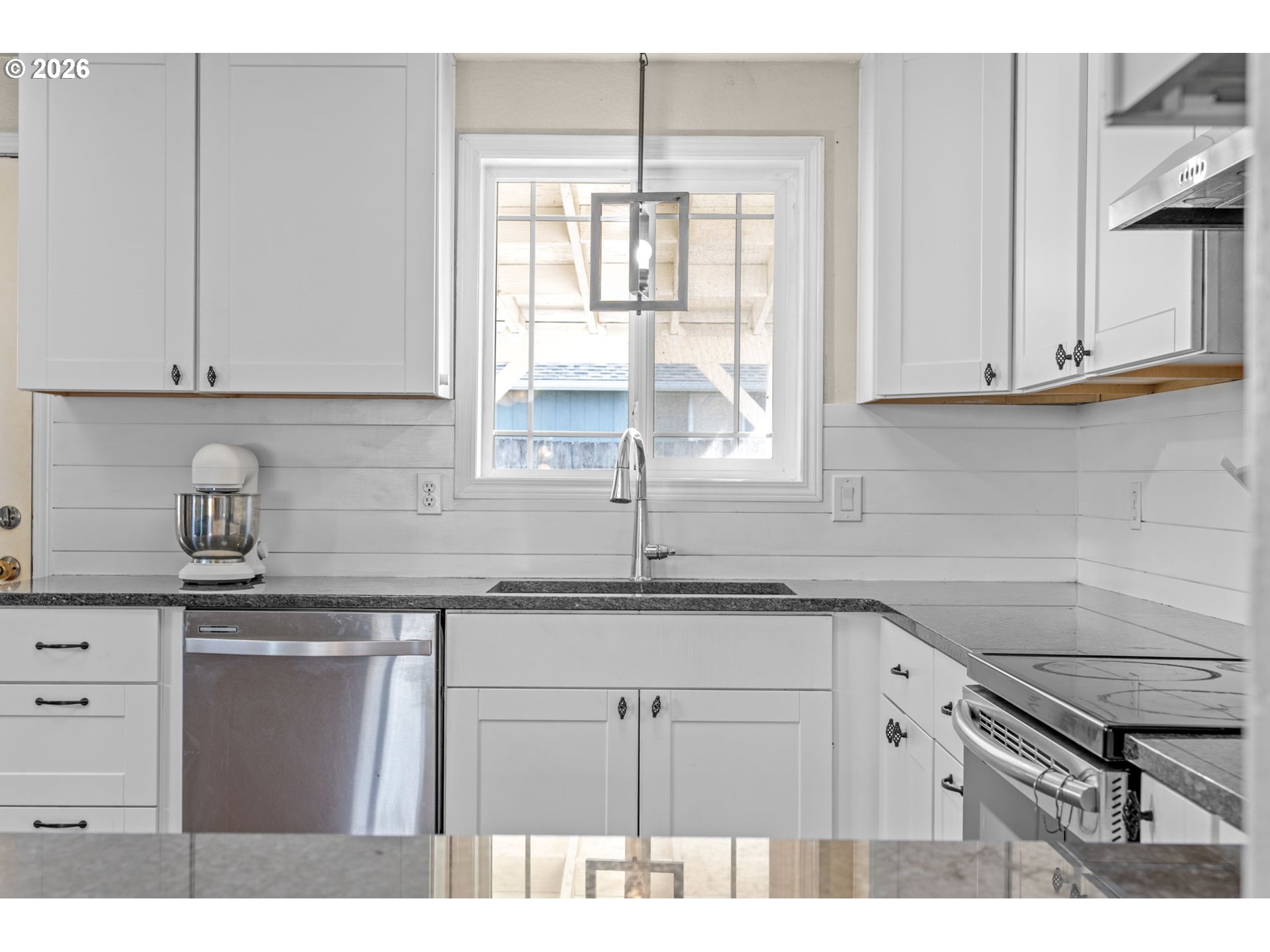 402 Clover Street Aumsville, OR 97325 - Photo 12 of 26 a kitchen with granite countertop a sink window and cabinets