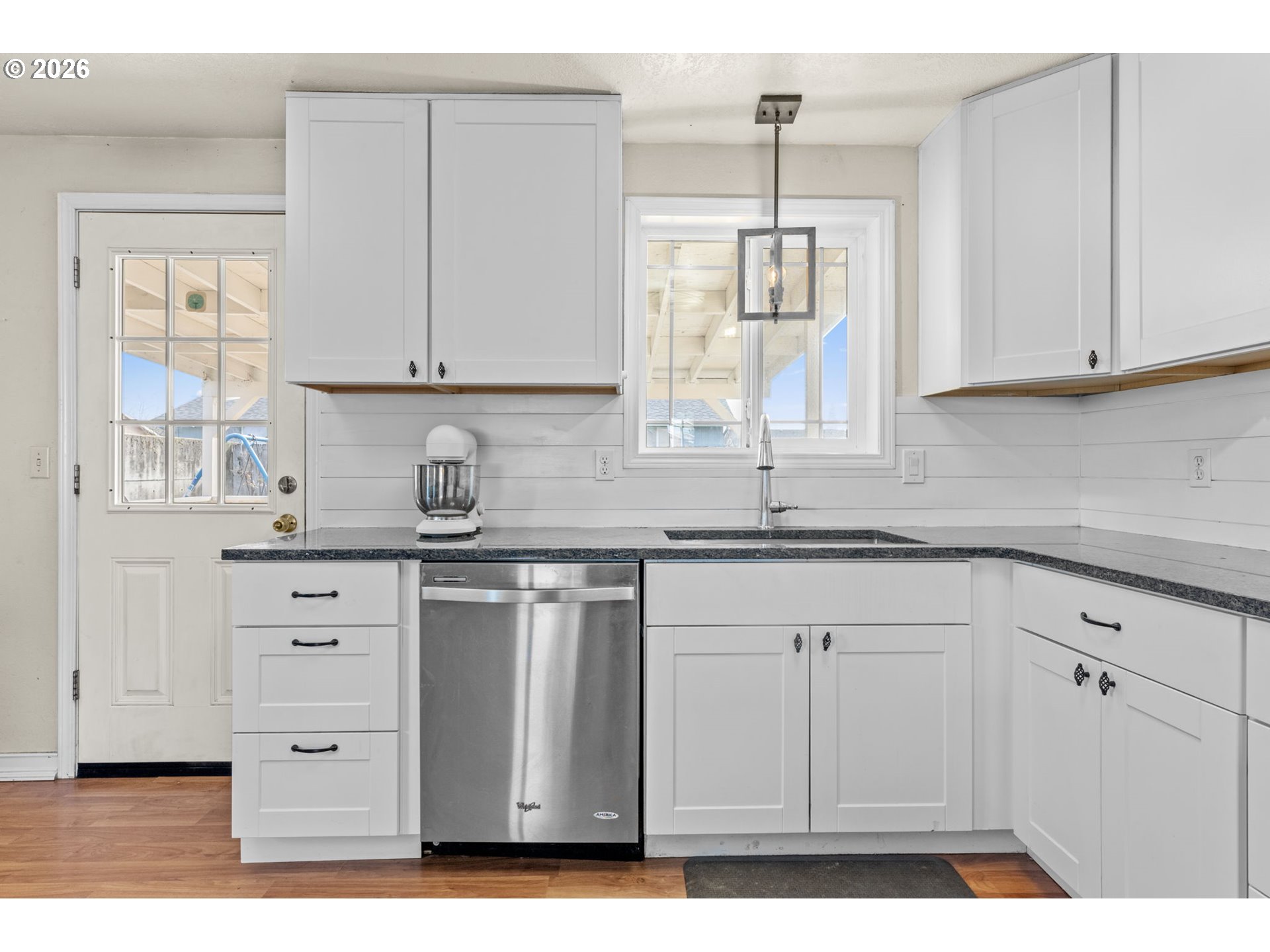402 Clover Street Aumsville, OR 97325 - Photo 8 of 26 a kitchen with cabinets appliances a sink and a window