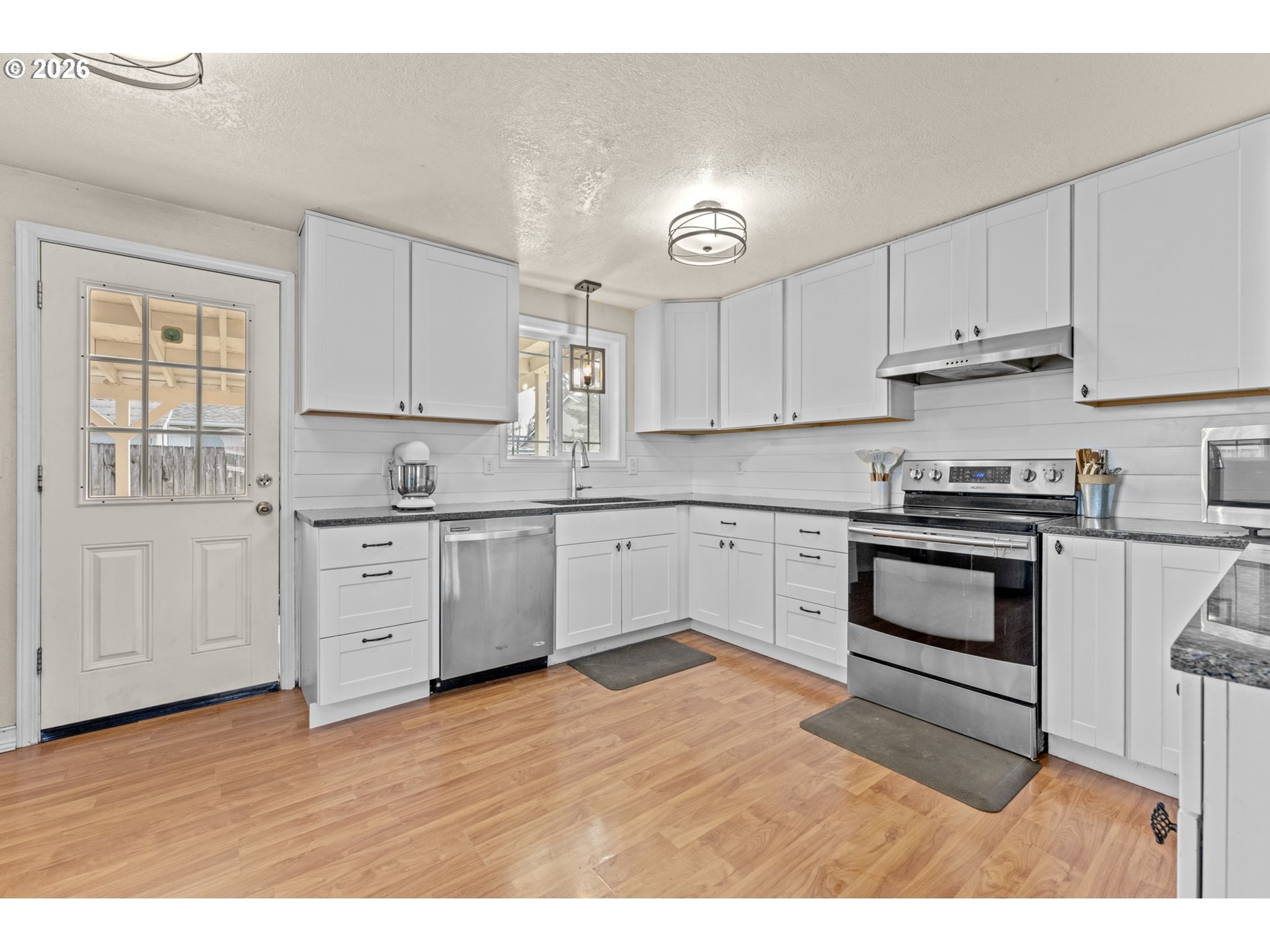402 Clover Street Aumsville, OR 97325 - Photo 9 of 26 a kitchen with cabinets stainless steel appliances and a window