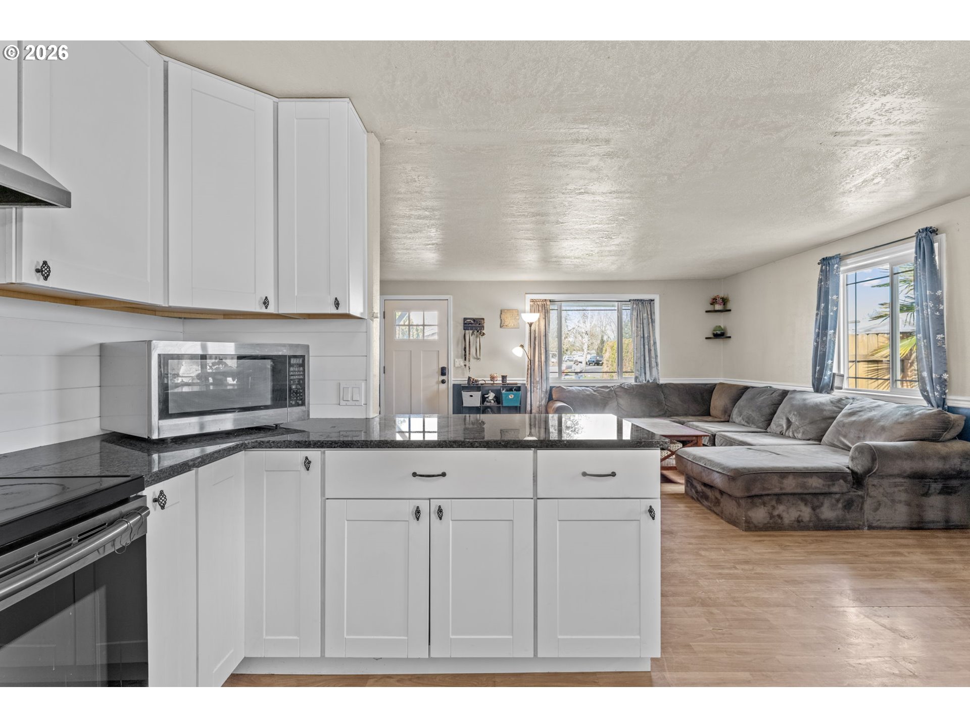 402 Clover Street Aumsville, OR 97325 - Photo 10 of 26 a kitchen with white cabinets and sink