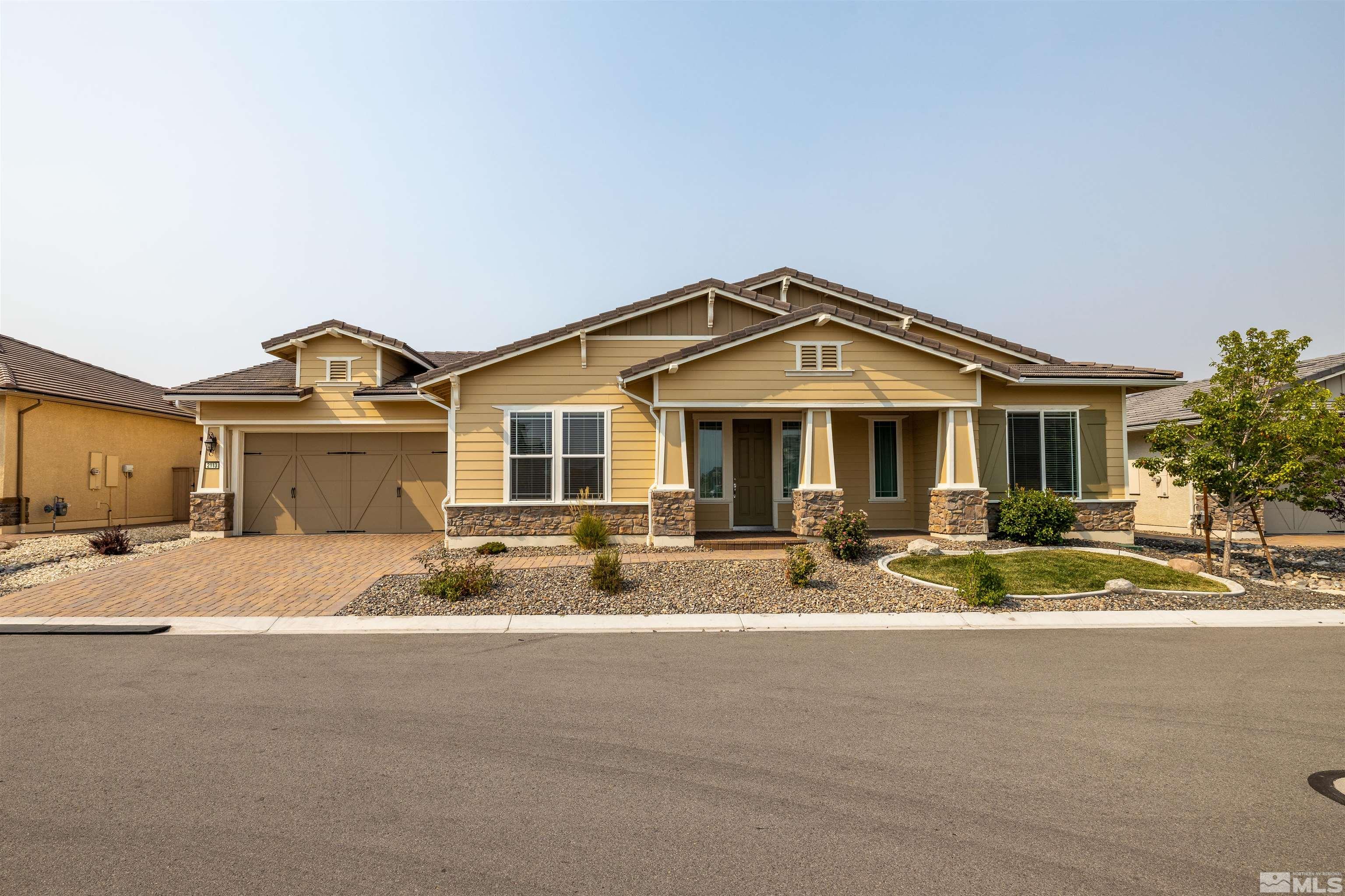 2113 Gregorgio Reno, NV 89521 - Photo 1 of 27 a front view of a house with a yard and garage