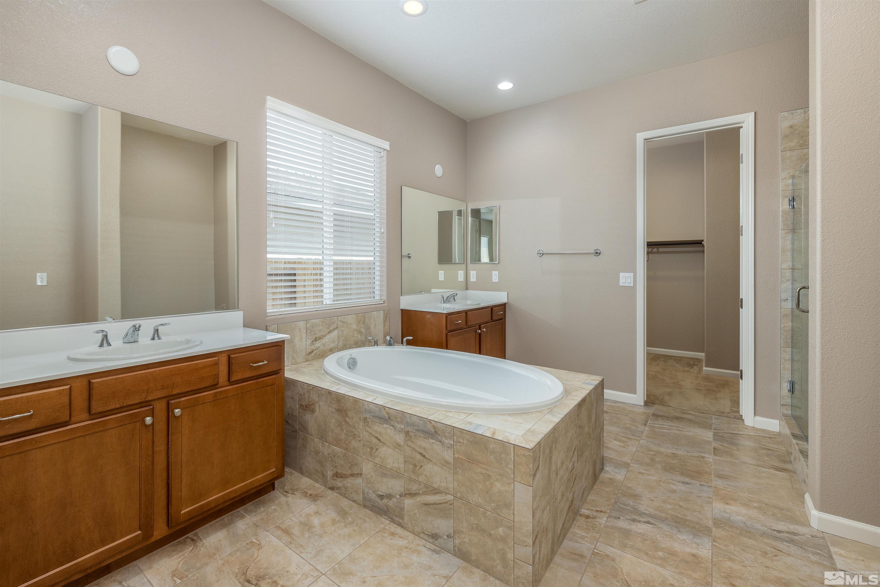 2113 Gregorgio Reno, NV 89521 - Photo 17 of 27 a bathroom with a sink a toilet a mirror and window