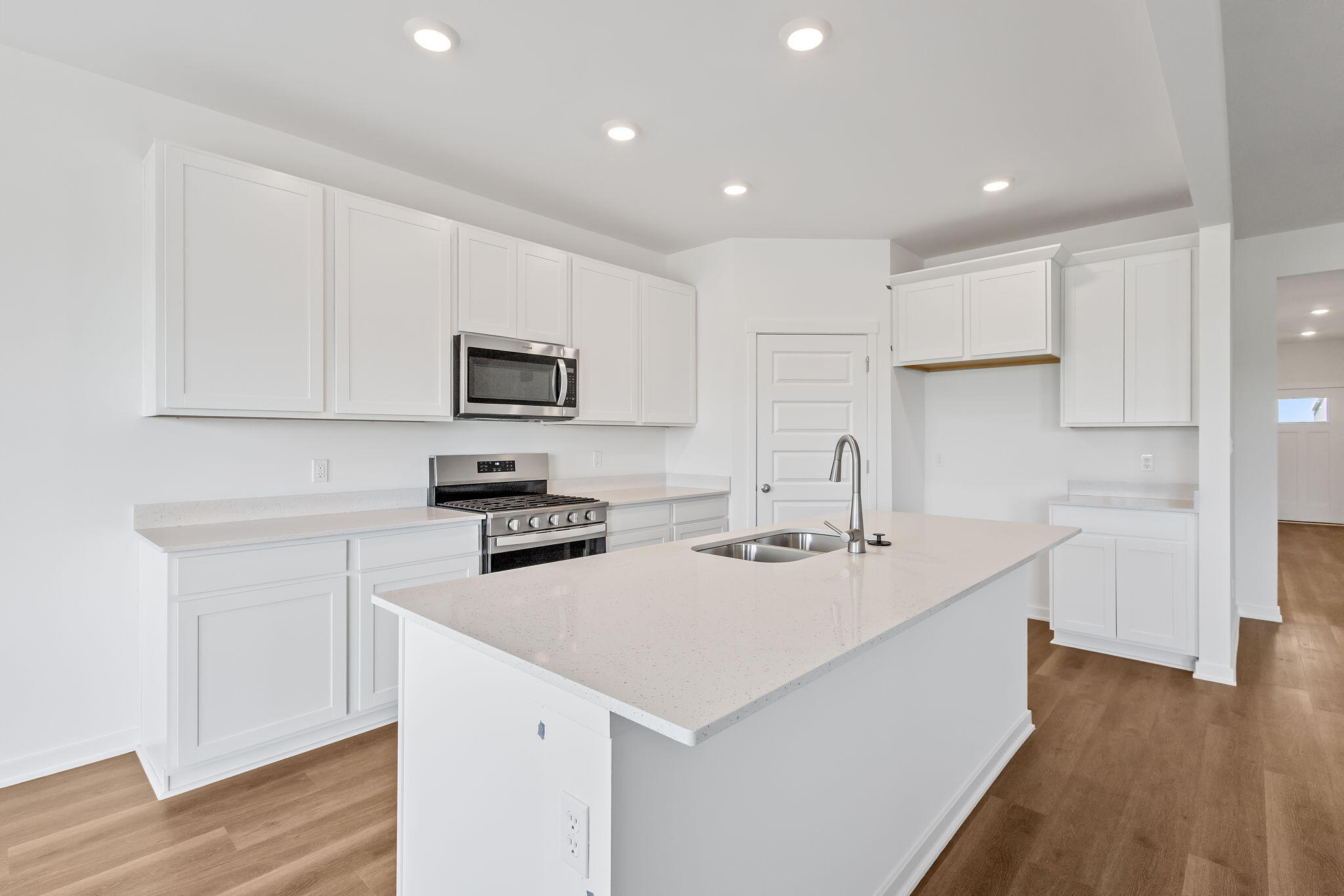 10650 Morse Place Crown Point, IN 46307 - Photo 2 of 15 a kitchen with a sink a stove a microwave and cabinets