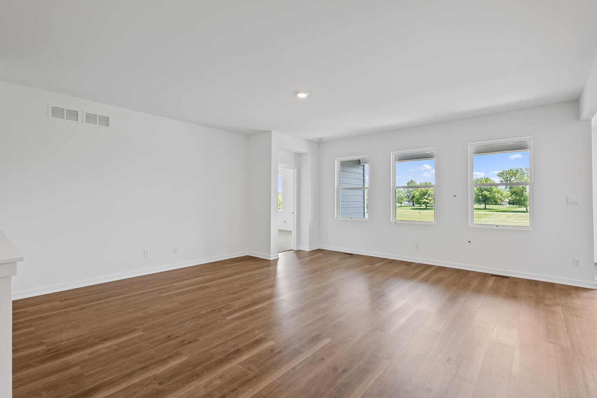 10650 Morse Place Crown Point, IN 46307 - Photo 5 of 15 an empty room with wooden floor and windows