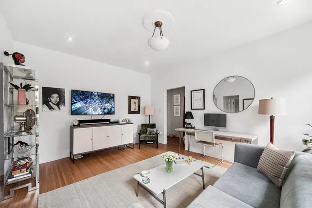 a living room with furniture and view of kitchen