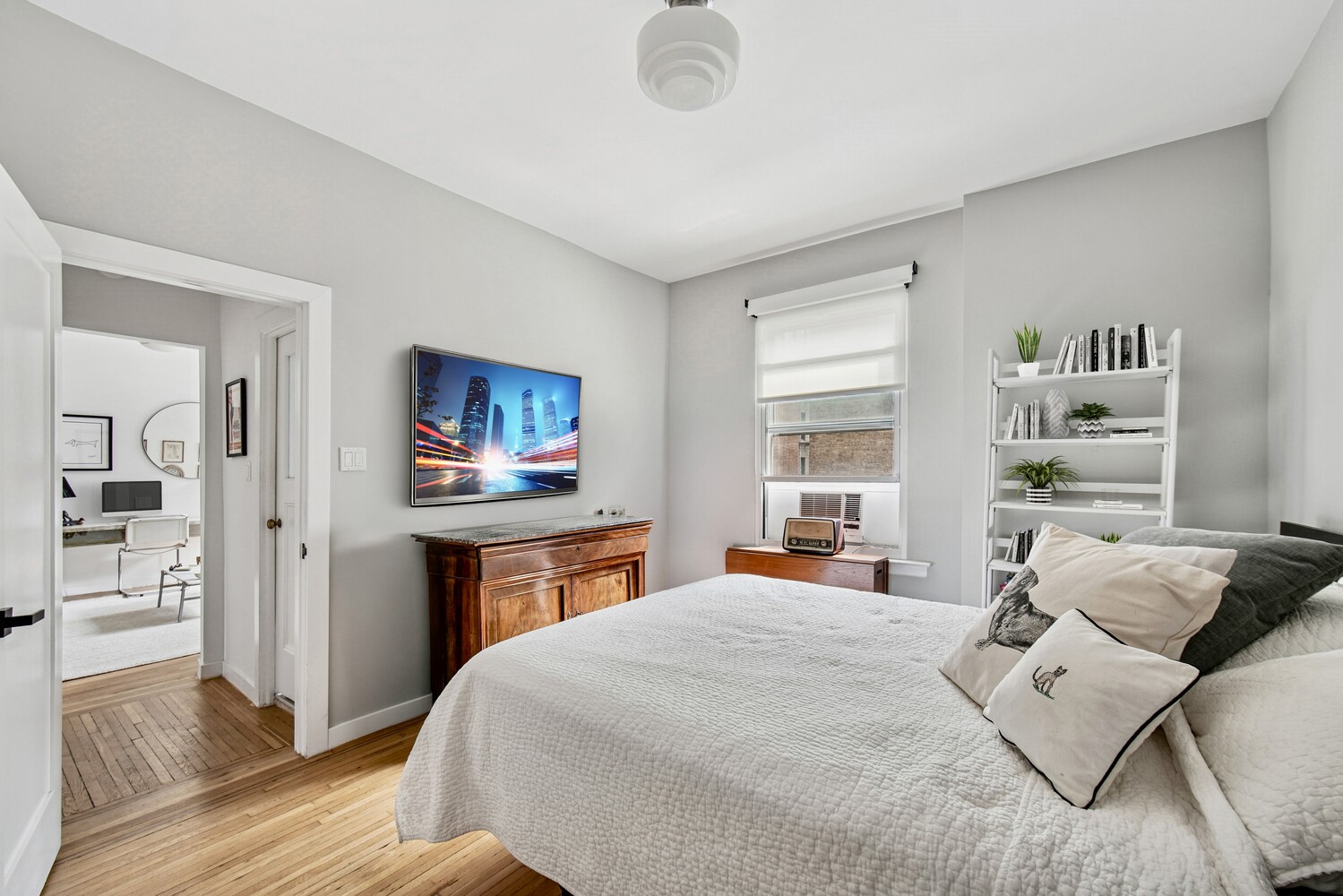 565 West 169th Street, Unit 3A Manhattan, NY 10032 - Photo 5 of 11 a bedroom with a bed and a flat screen tv