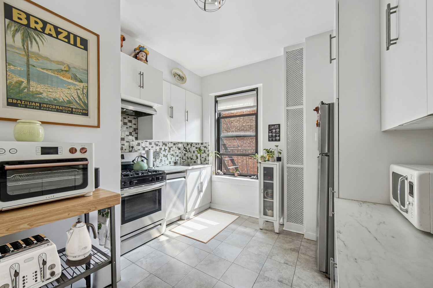 565 West 169th Street, Unit 3A Manhattan, NY 10032 - Photo 6 of 11 a kitchen with stainless steel appliances a stove a refrigerator and cabinets