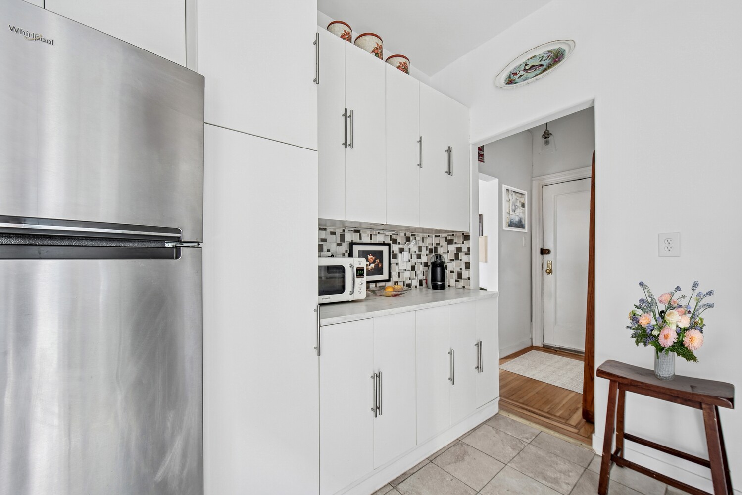 565 West 169th Street, Unit 3A Manhattan, NY 10032 - Photo 7 of 11 a hallway with white cabinets and wooden floor