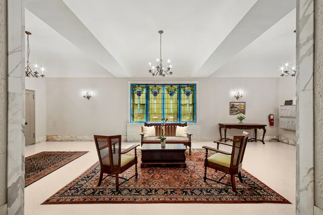 a living room with furniture a window and a chandelier
