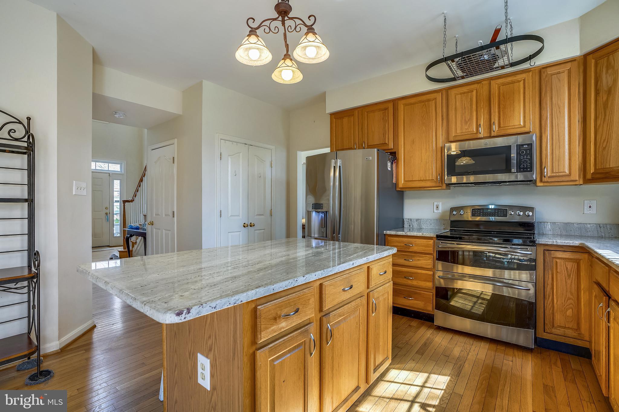 8004 Big Pool Road Laurel, MD 20724 - Photo 5 of 39 a kitchen with stainless steel appliances granite countertop a stove refrigerator and microwave