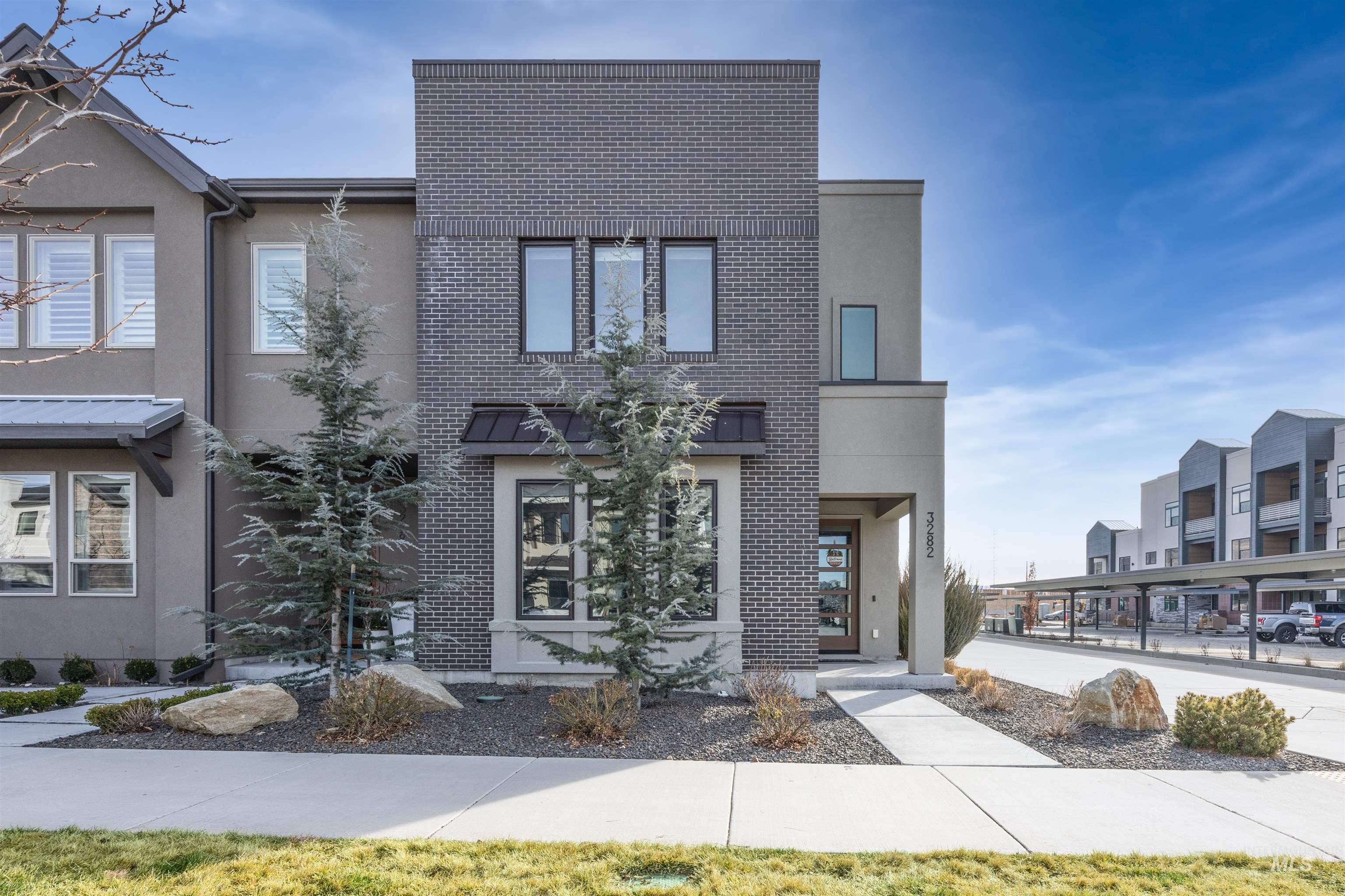 Contemporary house with stucco siding and brick siding