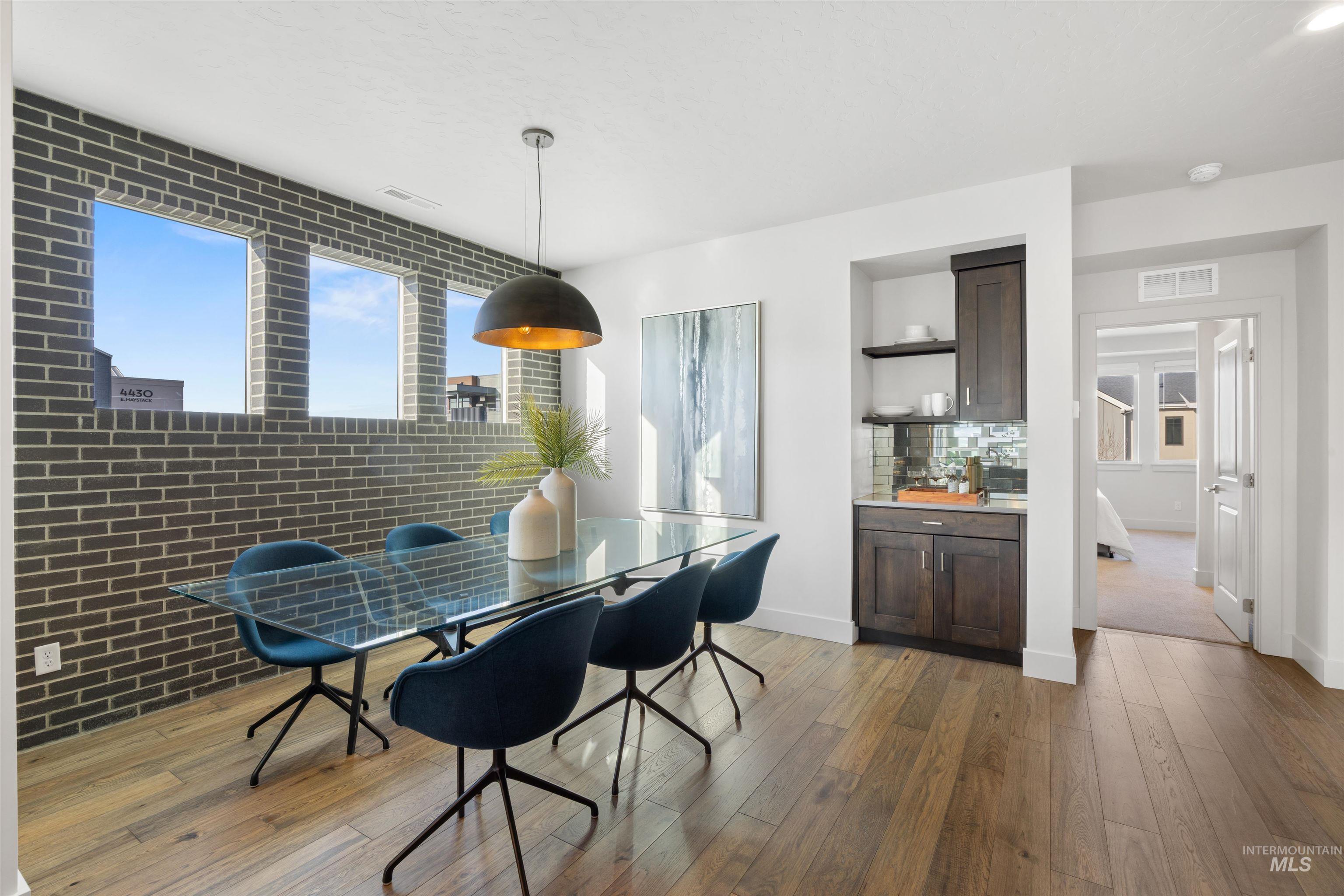 3282 South Millbrook Way Boise, ID 83716 - Photo 15 of 45 Dining space featuring dark wood-style flooring and brick wall