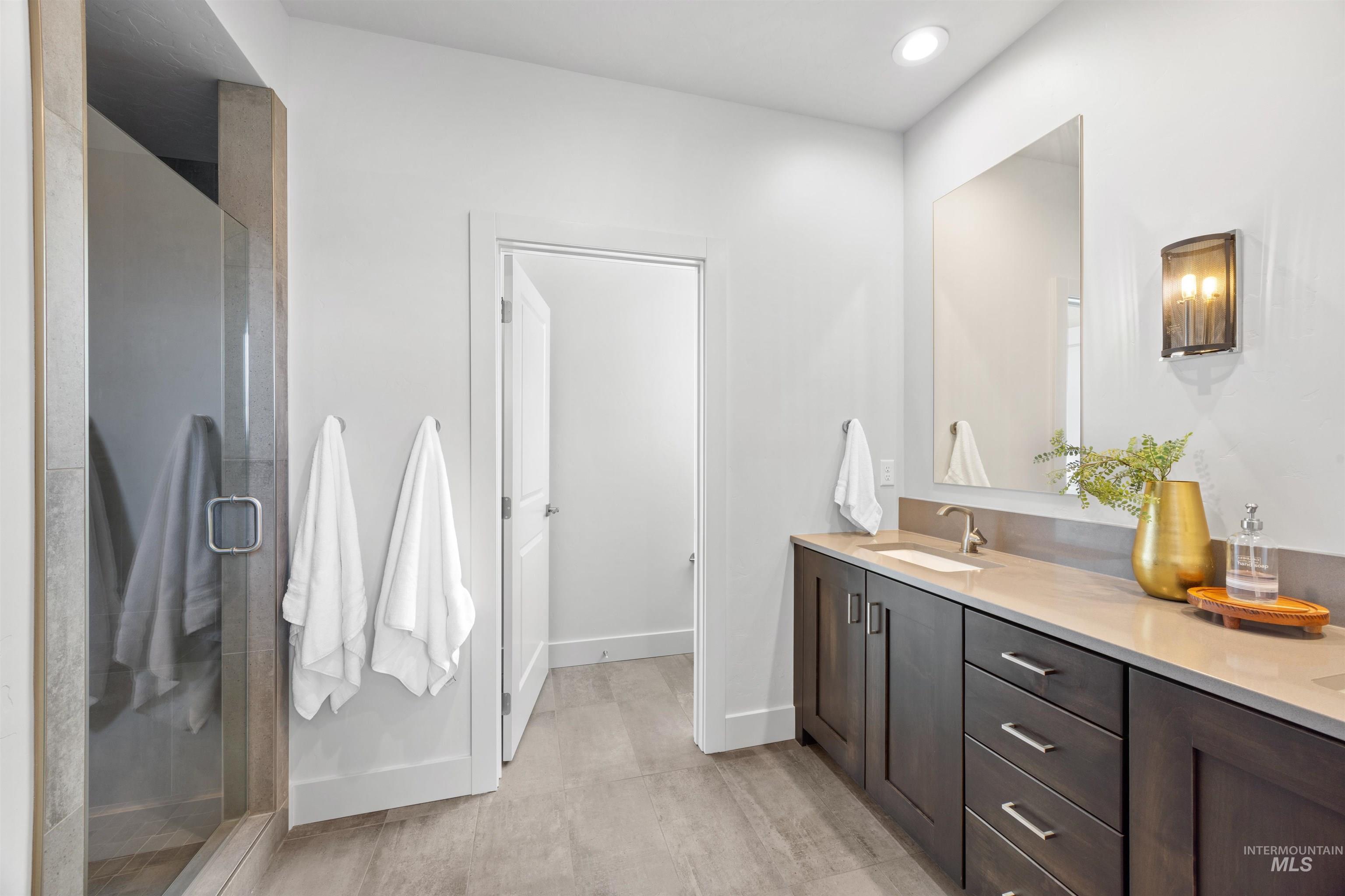 3282 South Millbrook Way Boise, ID 83716 - Photo 31 of 45 Full bath with double vanity, a stall shower, and recessed lighting