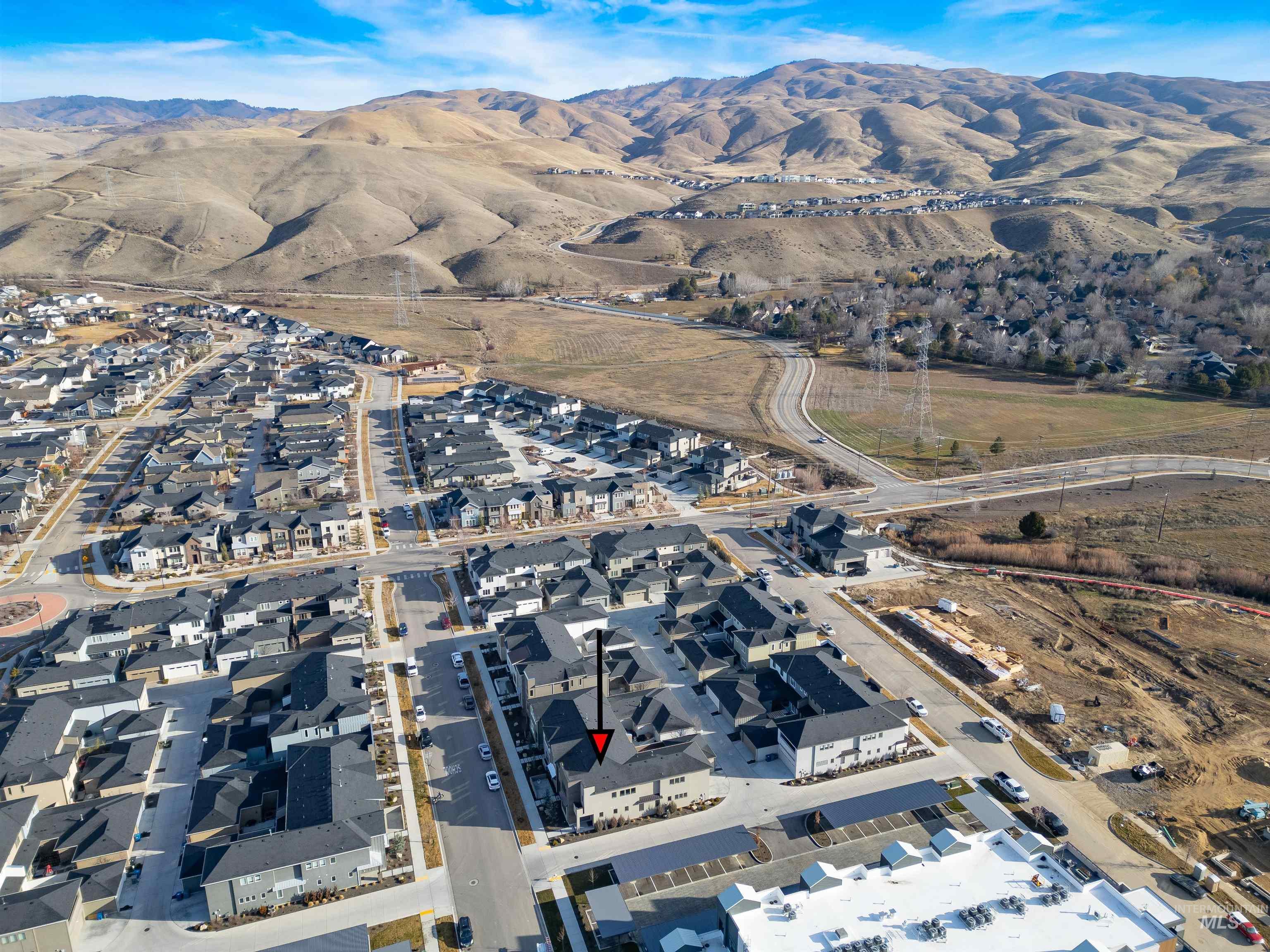 3282 South Millbrook Way Boise, ID 83716 - Photo 41 of 45 Aerial overview of property's location featuring a mountain backdrop and nearby suburban area