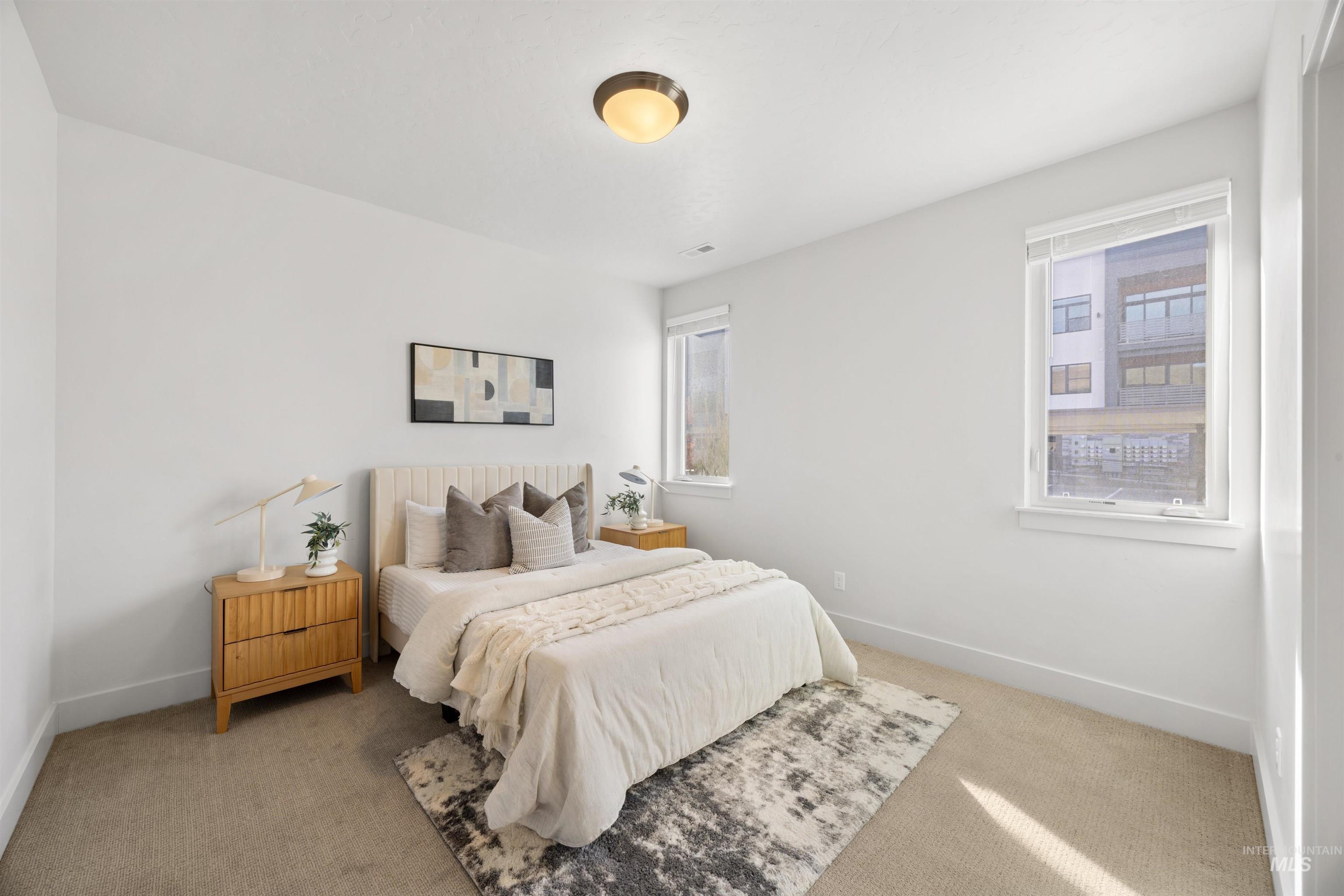 3282 South Millbrook Way Boise, ID 83716 - Photo 7 of 45 Bedroom with light colored carpet and baseboards