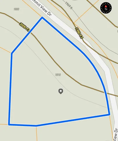 an aerial view of a house with a yard and garden