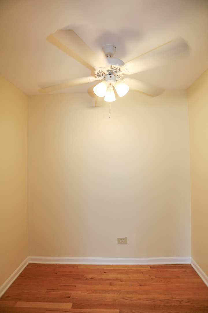 521 West Briar Place, Unit 201 Chicago, IL 60657 - Photo 5 of 9 a view of a small space with wooden floor and a fan