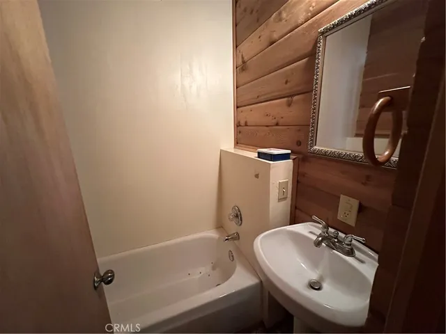 a bathroom with a toilet mirror and sink