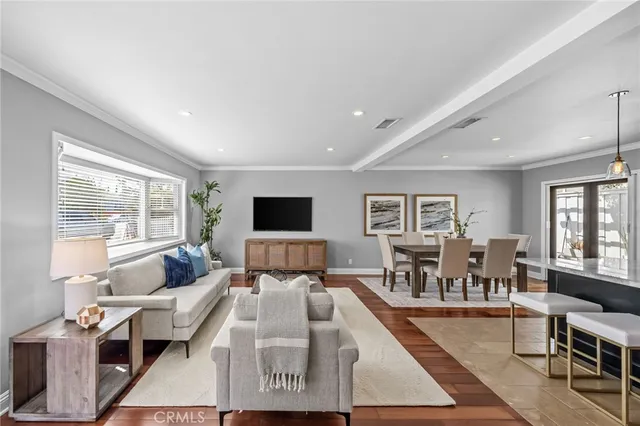 a living room with furniture large window and a table