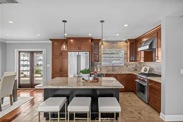 a kitchen with granite countertop a dining table chairs and sink