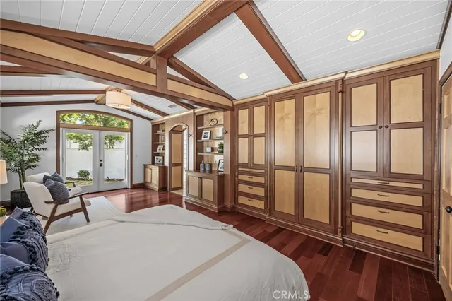 a bedroom with furniture and large windows