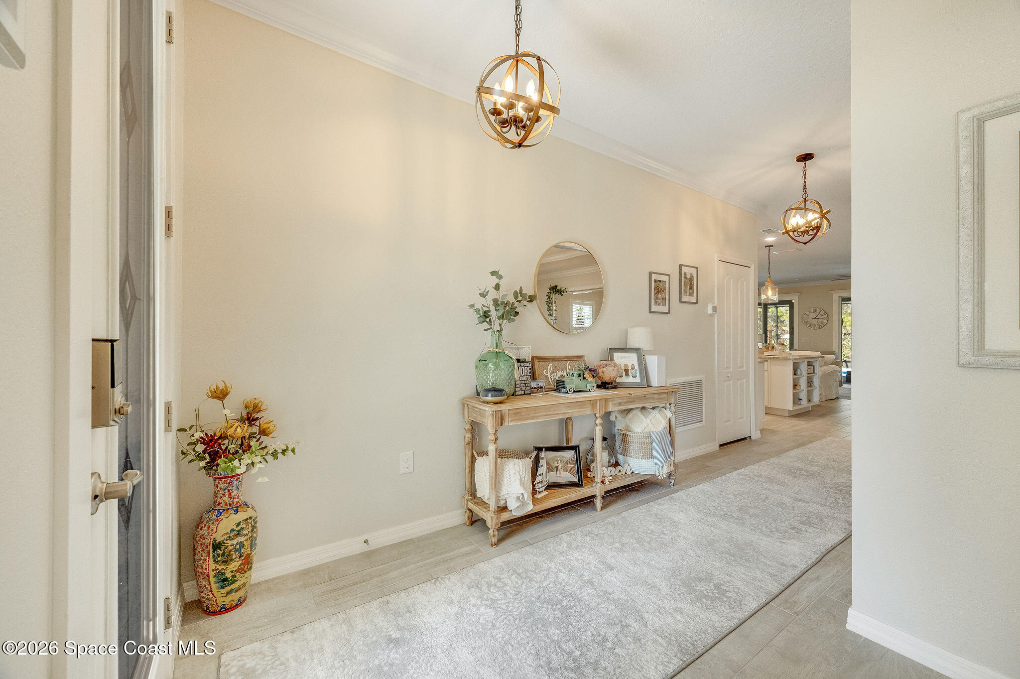 3470 Breezy Point Lane Cocoa, FL 32926 - Photo 2 of 69 a room with cabinets and a chandelier