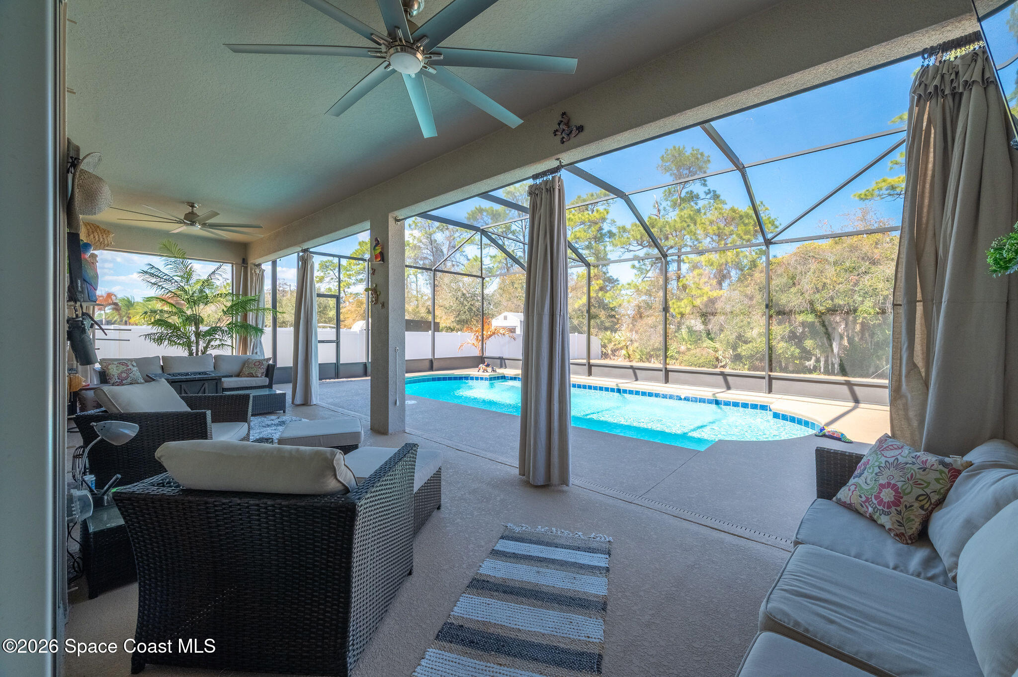 3470 Breezy Point Lane Cocoa, FL 32926 - Photo 31 of 69 a living room with furniture and a floor to ceiling window