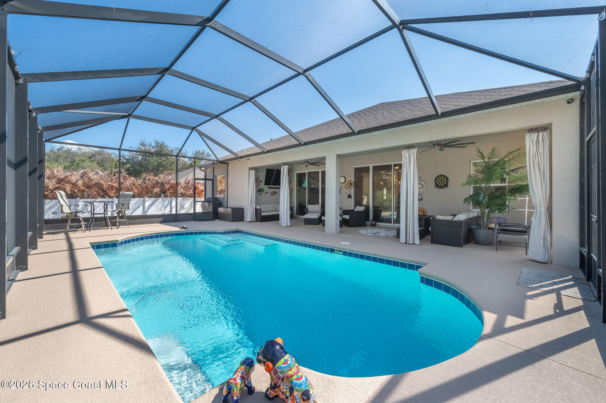 3470 Breezy Point Lane Cocoa, FL 32926 - Photo 36 of 69 a view of a patio with table and chairs under an umbrella