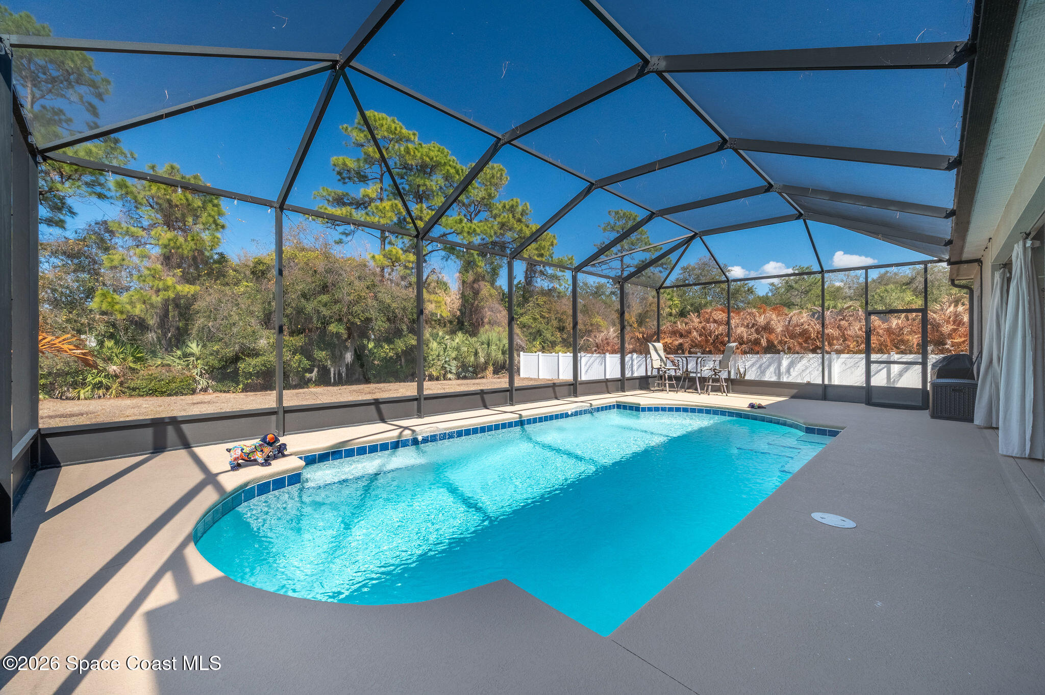 3470 Breezy Point Lane Cocoa, FL 32926 - Photo 40 of 69 a view of a backyard with a swimming pool