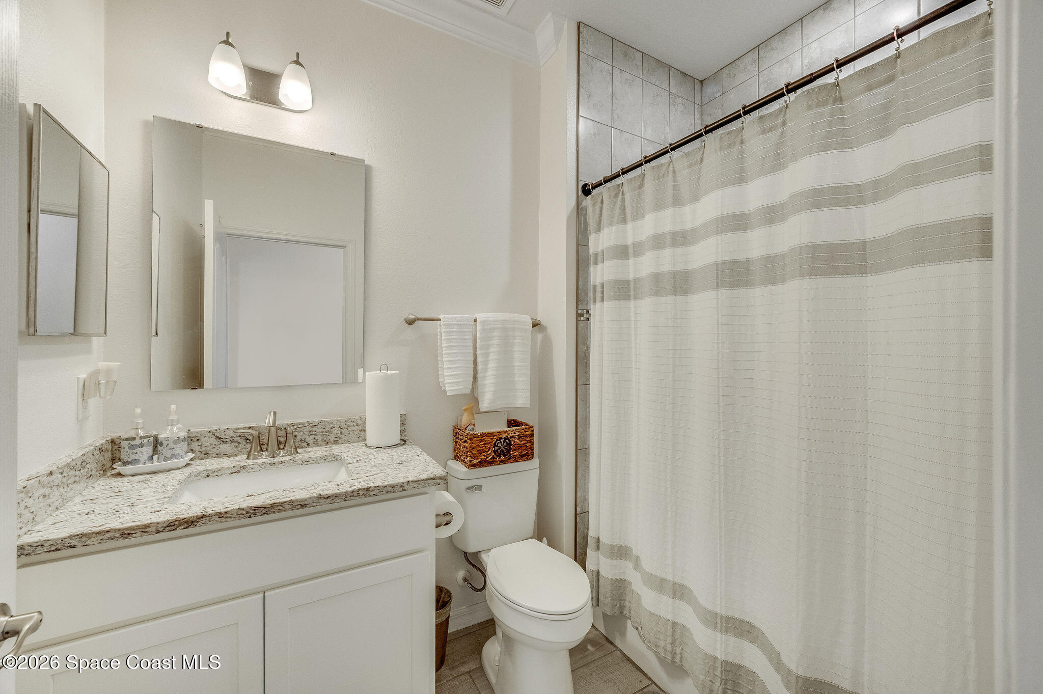 3470 Breezy Point Lane Cocoa, FL 32926 - Photo 51 of 69 a bathroom with a granite countertop sink toilet and a mirror