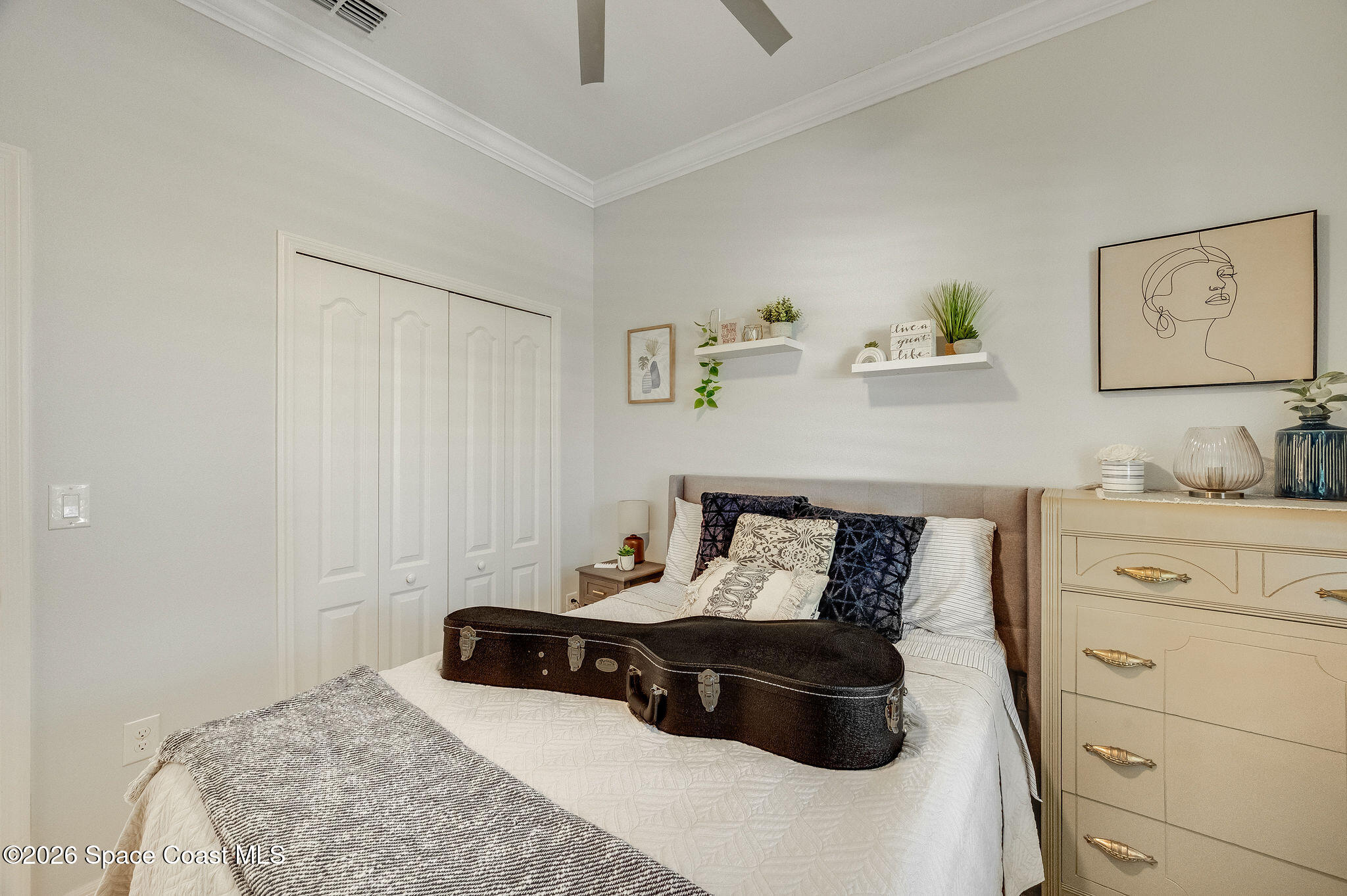 3470 Breezy Point Lane Cocoa, FL 32926 - Photo 52 of 69 a bedroom with a bed and cabinets