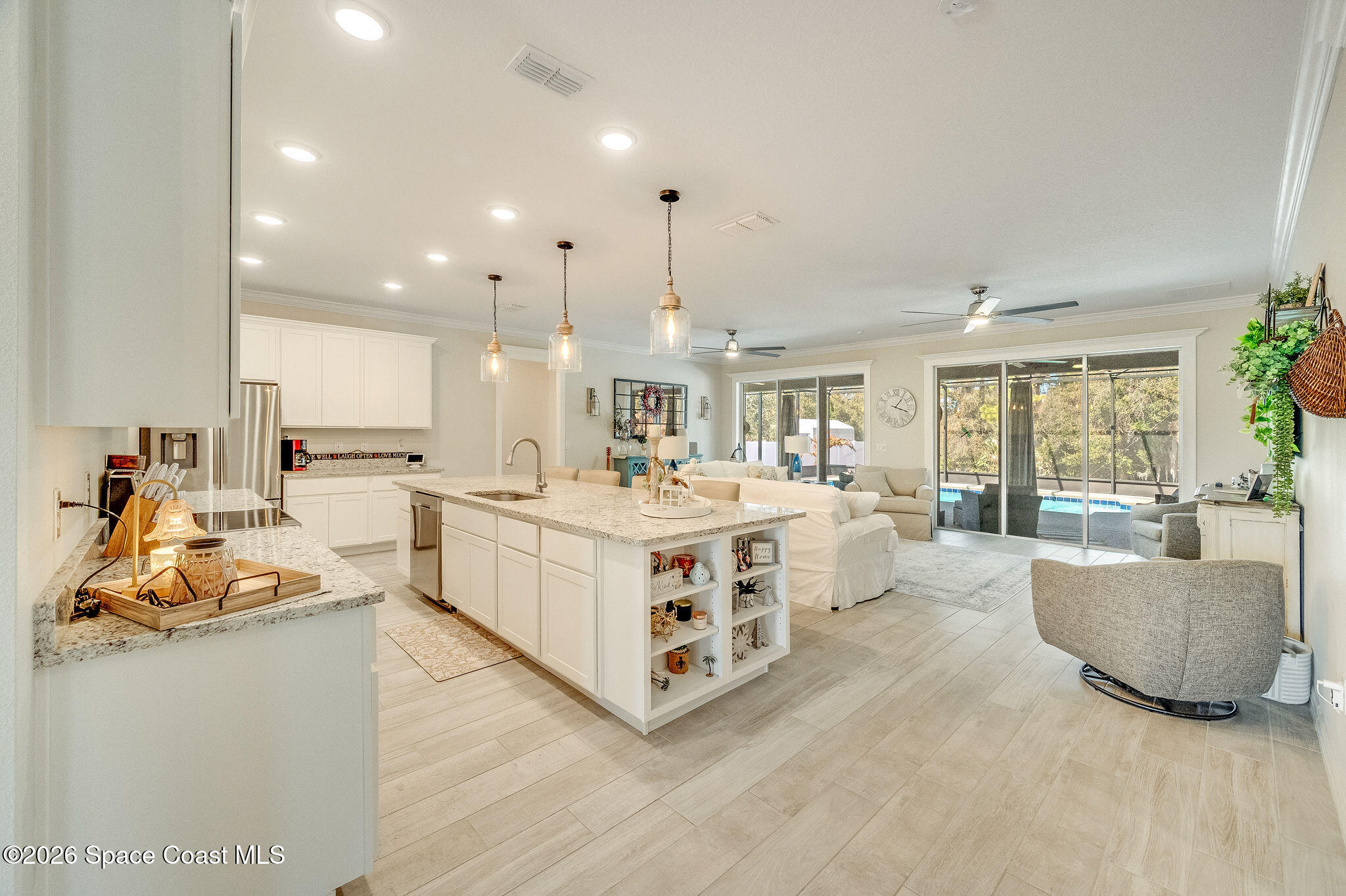 3470 Breezy Point Lane Cocoa, FL 32926 - Photo 8 of 69 a large white kitchen with a large counter top a sink stainless steel appliances and cabinets