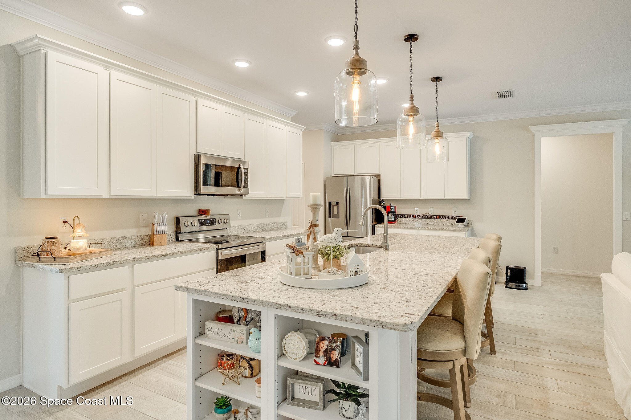 3470 Breezy Point Lane Cocoa, FL 32926 - Photo 10 of 69 a kitchen with kitchen island granite countertop a sink a center island and appliances