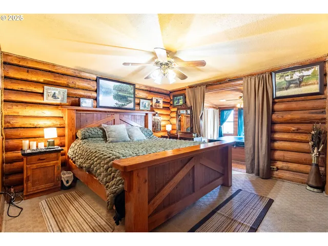 a bedroom with a bed and a view of kitchen