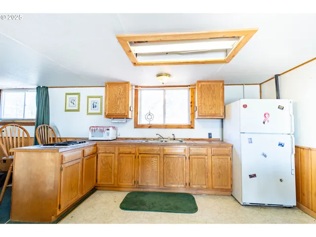 a kitchen with a stove a refrigerator and a sink