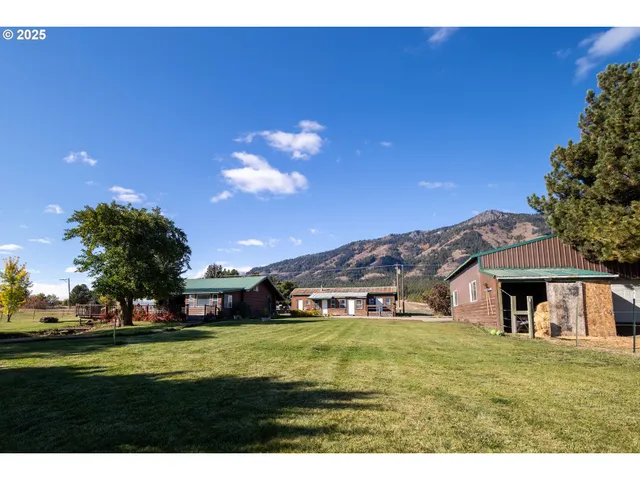 a view of a patio with dining table and chairs with wooden floor