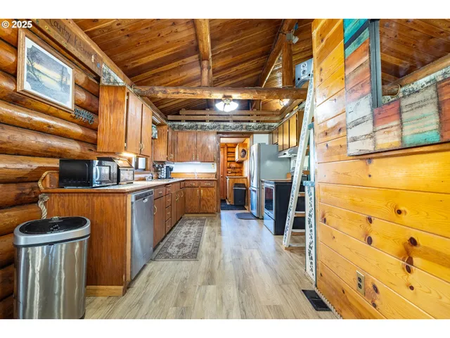 a kitchen view of a lot of cabinets and wooden floor