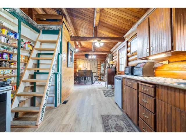 a view of a living room with furniture and wooden floor