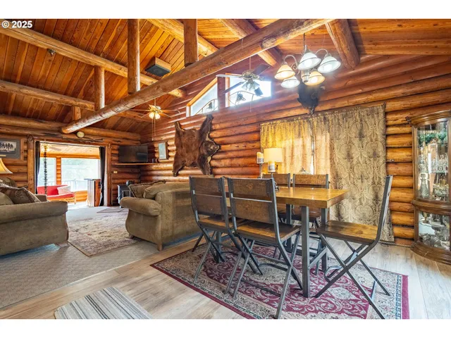 a dining room with furniture and a chandelier