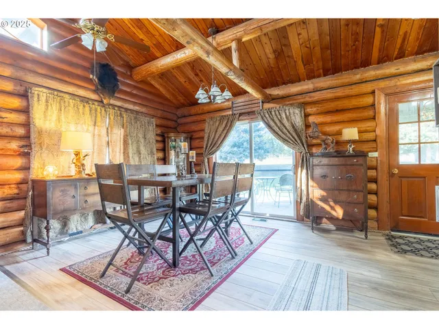 a dining room with a wooden table and chairs