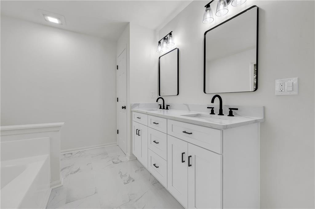 2941 Lake Hollow Road Gainesville, GA 30501 - Photo 29 of 53 a bathroom with double vanity sink and mirror